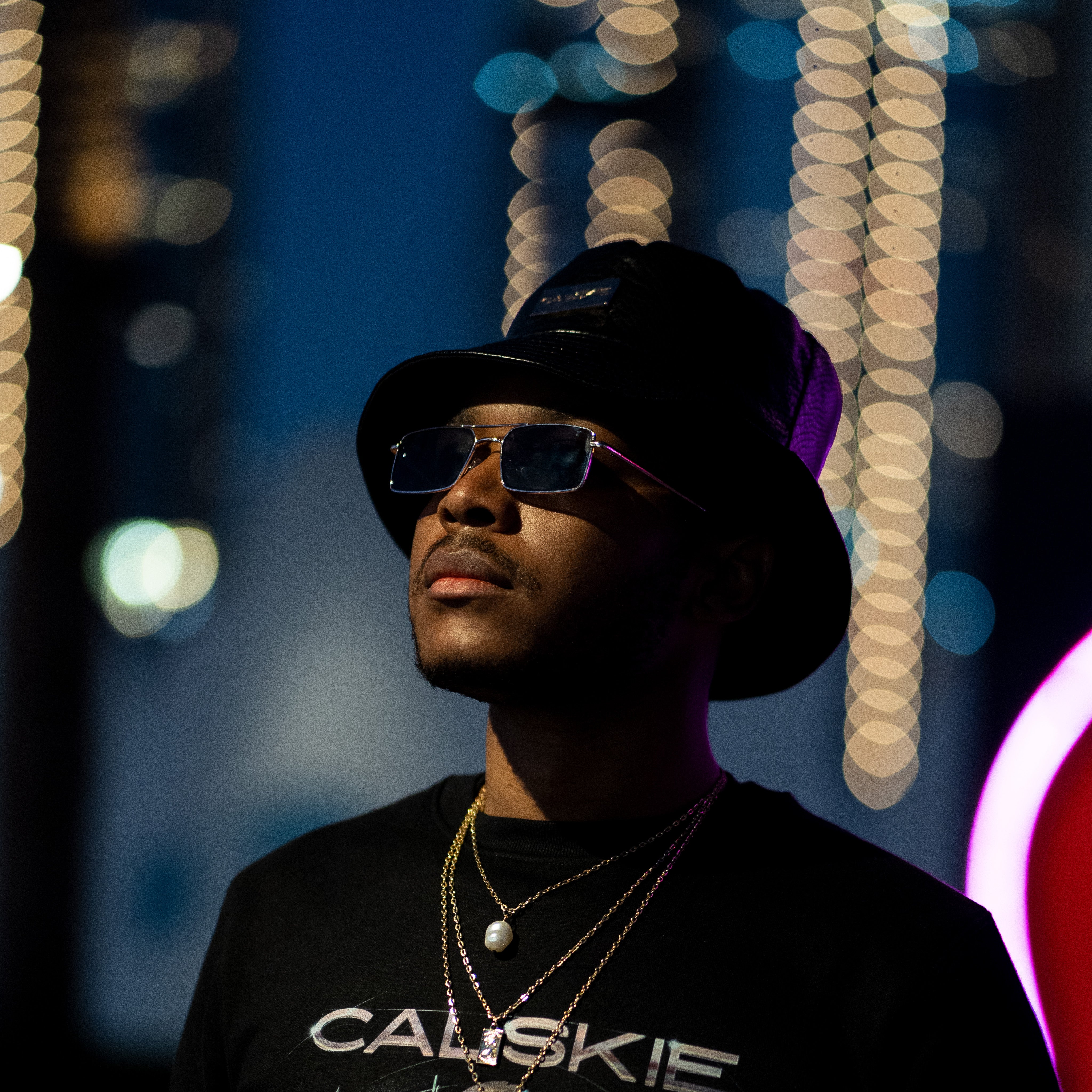 An image showing the black crocodile pattern leather bucket hat by Calskie, featuring the gold Calskie logo on the front.